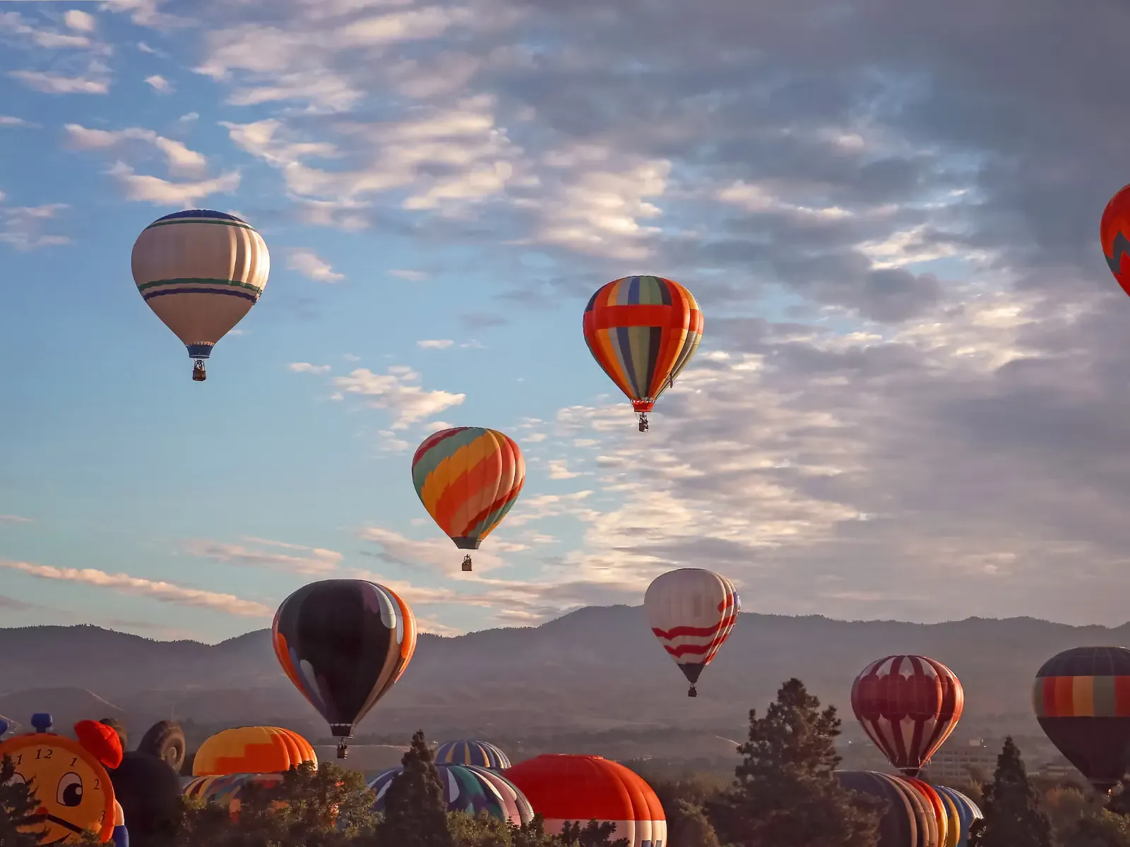 Hot air balloon flying over Marrakech at sunrise